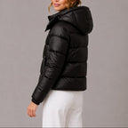 Women's quilted hooded puffer jacket shown in navy and black with long sleeves and front pockets