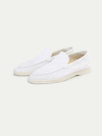 Men's white slip-on loafers with moc toe stitching and flat soles