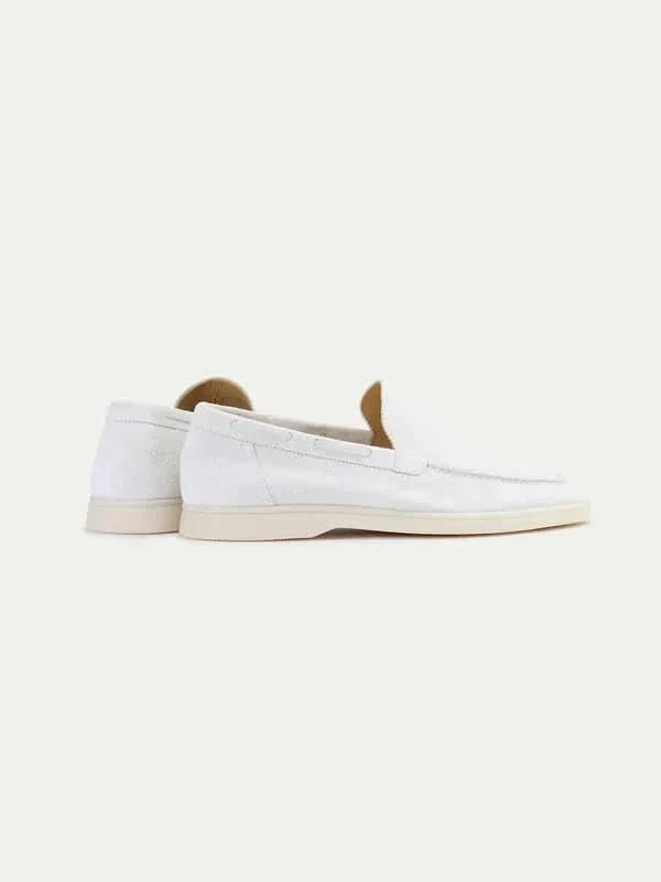 Men's white slip-on loafers with moc toe stitching and flat soles