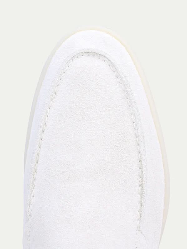 Men's white slip-on loafers with moc toe stitching and flat soles