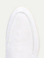 Men's white slip-on loafers with moc toe stitching and flat soles