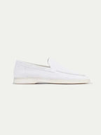 Men's white slip-on loafers with moc toe stitching and flat soles