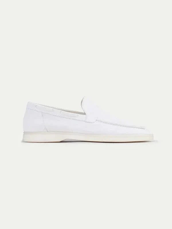Men's white slip-on loafers with moc toe stitching and flat soles