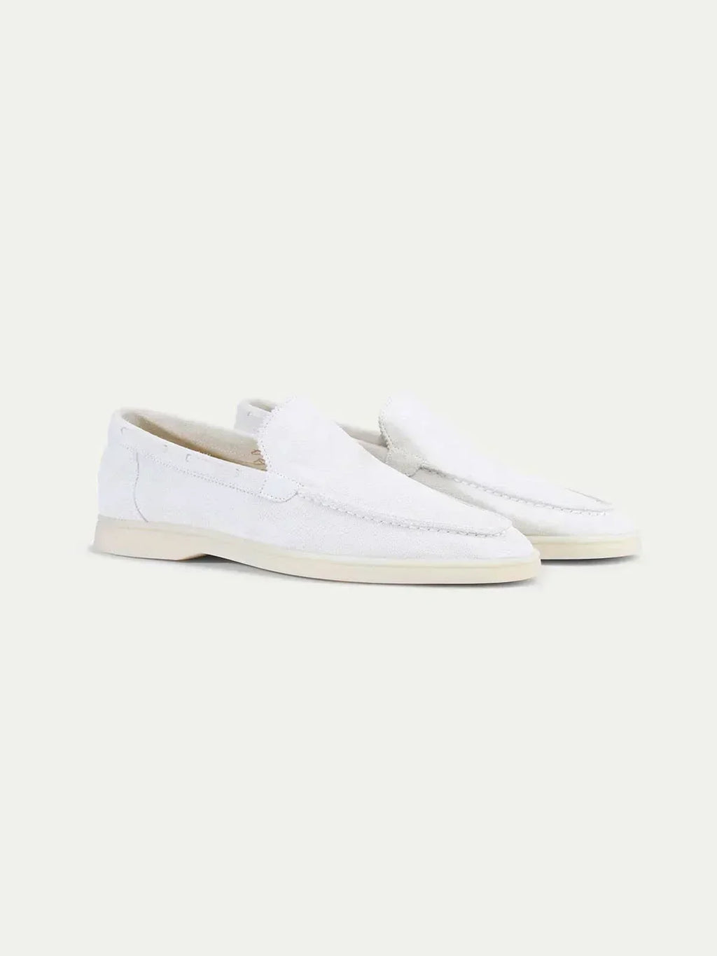 Men's white slip-on loafers with moc toe stitching and flat soles