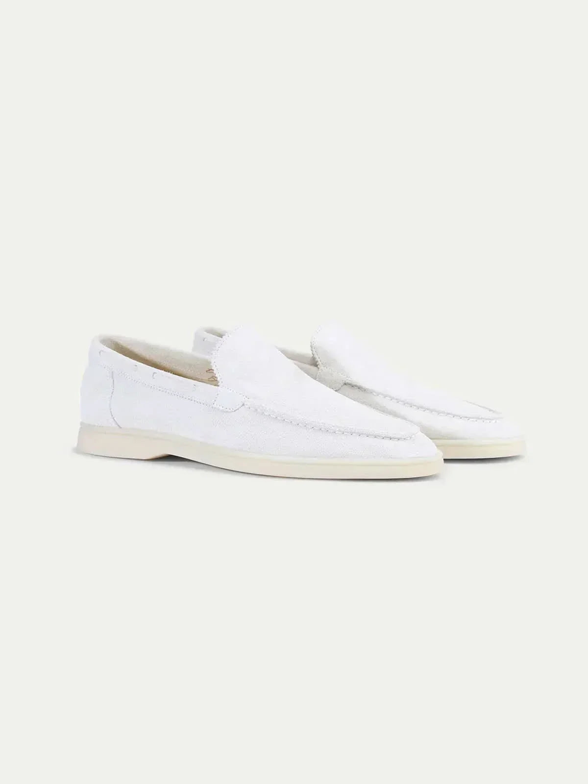Men's white slip-on loafers with moc toe stitching and flat soles
