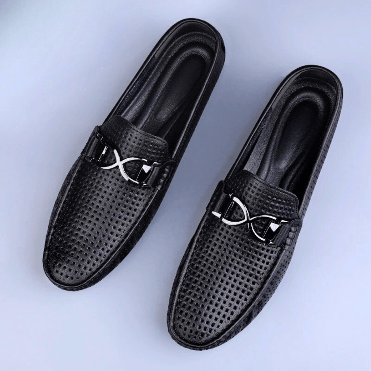 Perforated driving loafer with metal trim and flat treaded sole