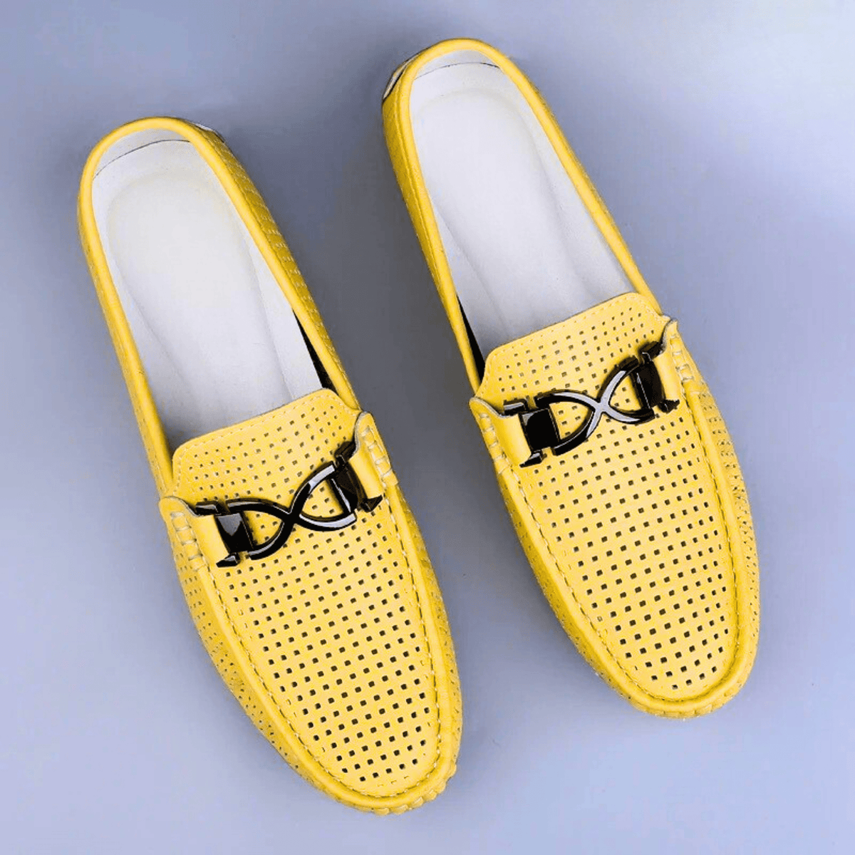 Perforated driving loafer with metal trim and flat treaded sole