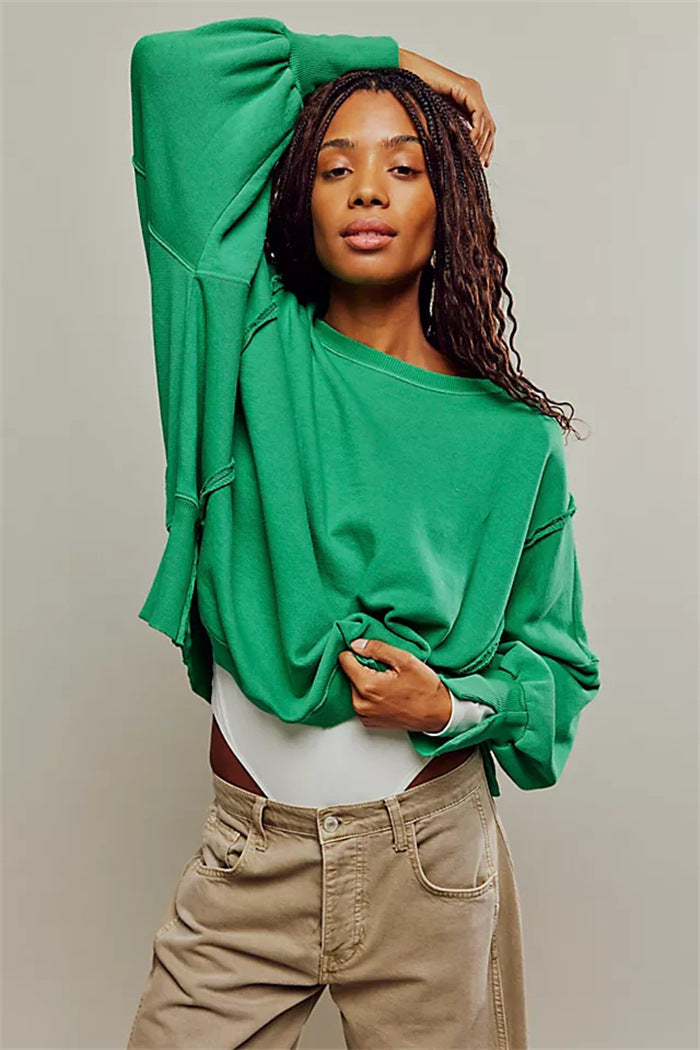 Women's oversized sweatshirt with balloon sleeves, exposed seams and side slits