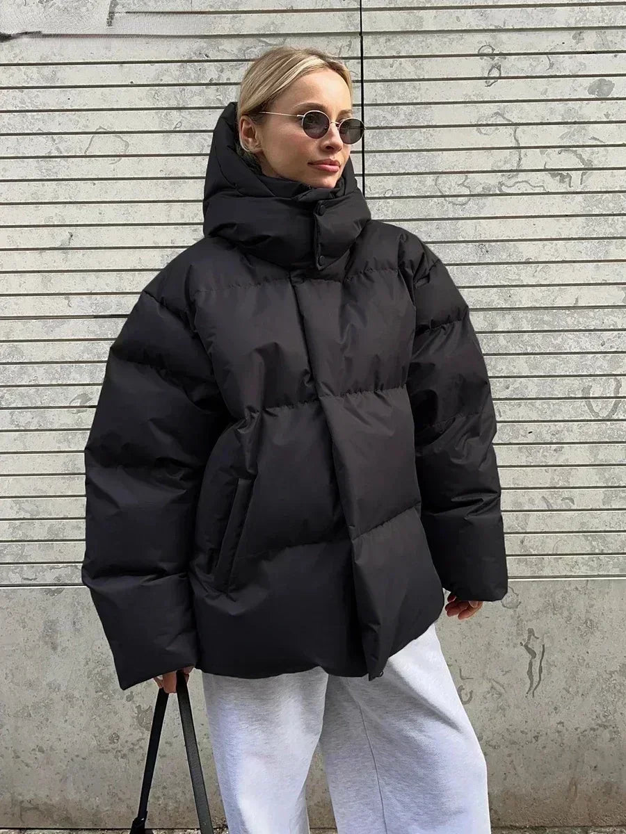 Women's oversized hooded puffer jacket with long sleeves and side pockets