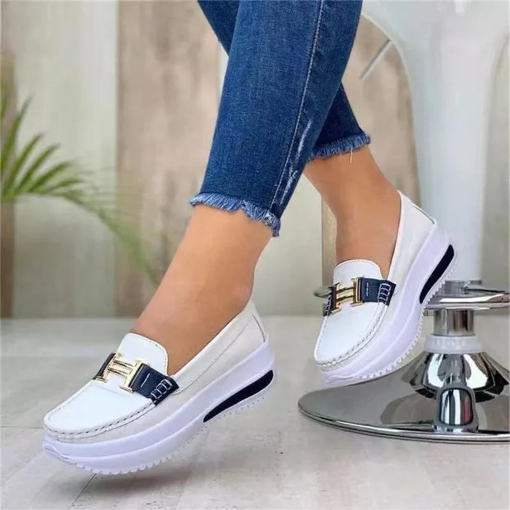 Women's platform loafers with moc toe, metallic buckle trim and raised sole