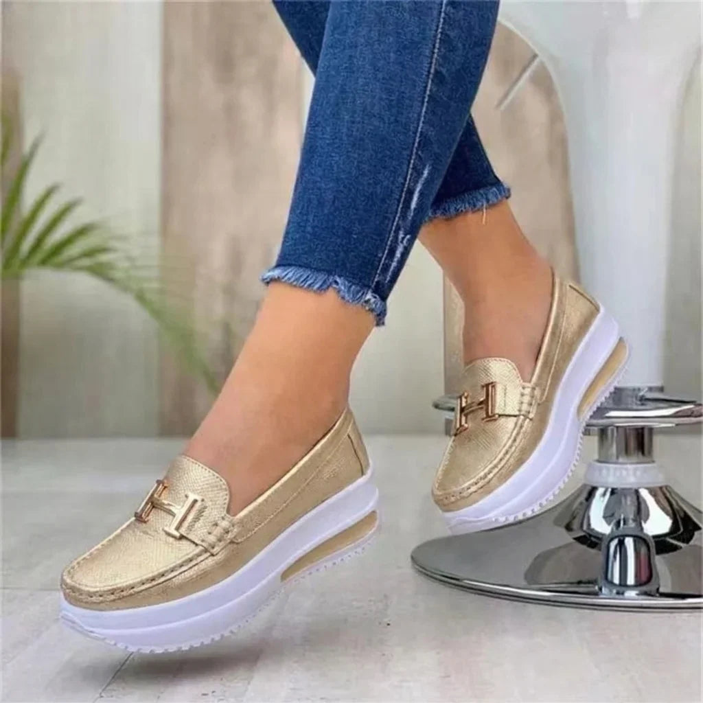 Women's platform loafers with moc toe, metallic buckle trim and raised sole