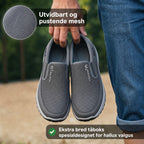 Men's slip-on athletic shoes with round toes, pull tabs and contrasting soles