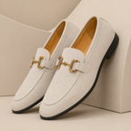 Men's slip-on loafers with decorative buckle and low heel shown in beige and black