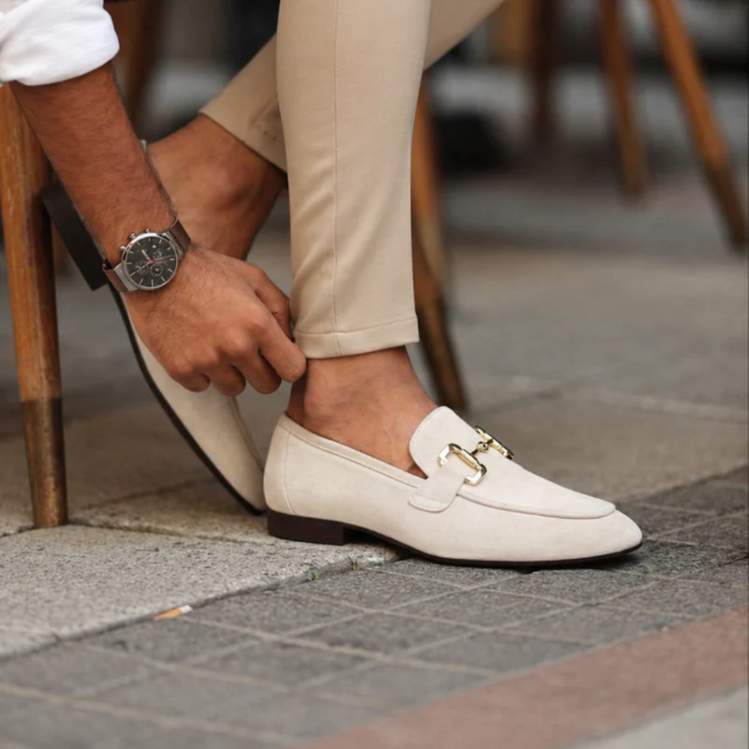 Men's slip-on loafers with decorative buckle and low heel shown in beige and black