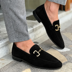 Men's slip-on loafers with decorative buckle and low heel shown in beige and black