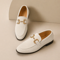 Men's slip-on loafers with decorative buckle and low heel shown in beige and black