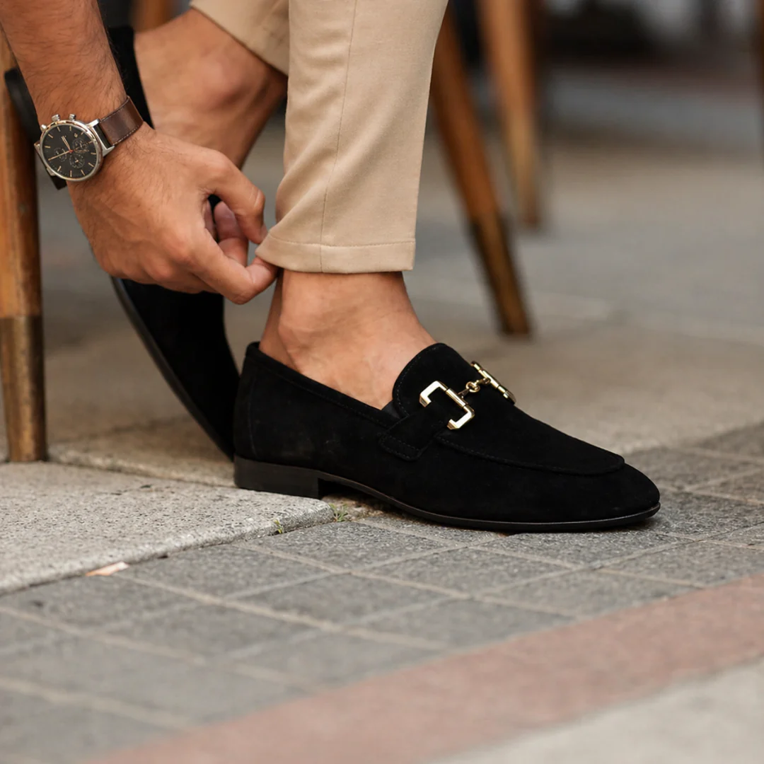 Men's slip-on loafers with decorative buckle and low heel shown in beige and black