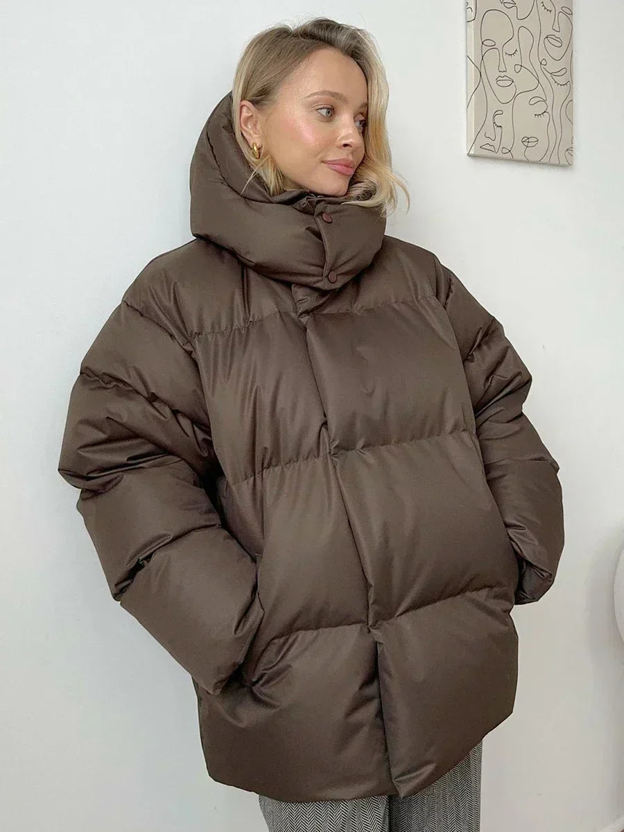 Women's oversized hooded puffer jacket with long sleeves and side pockets
