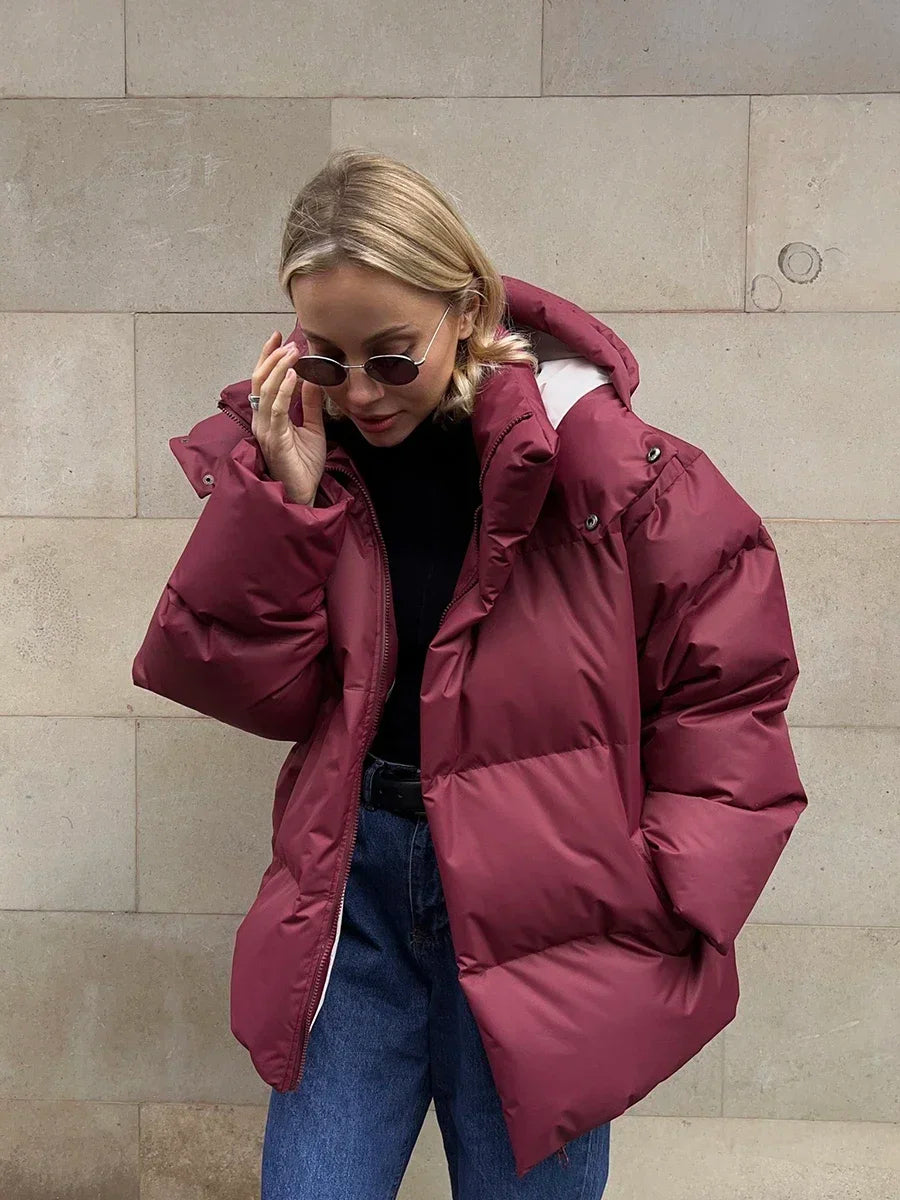 Women's oversized hooded puffer jacket with long sleeves and side pockets