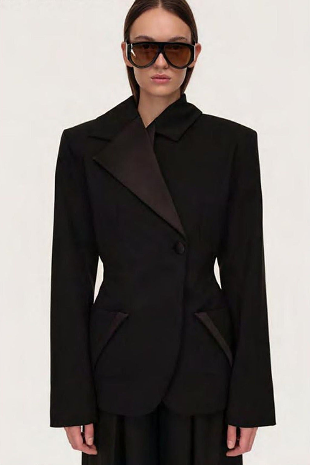 Women's black sculpted blazer with notched lapels and long sleeves