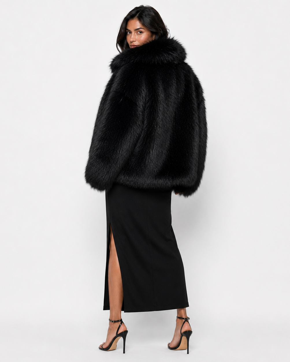 Woman wearing a black long-haired fur coat with a wide collar
