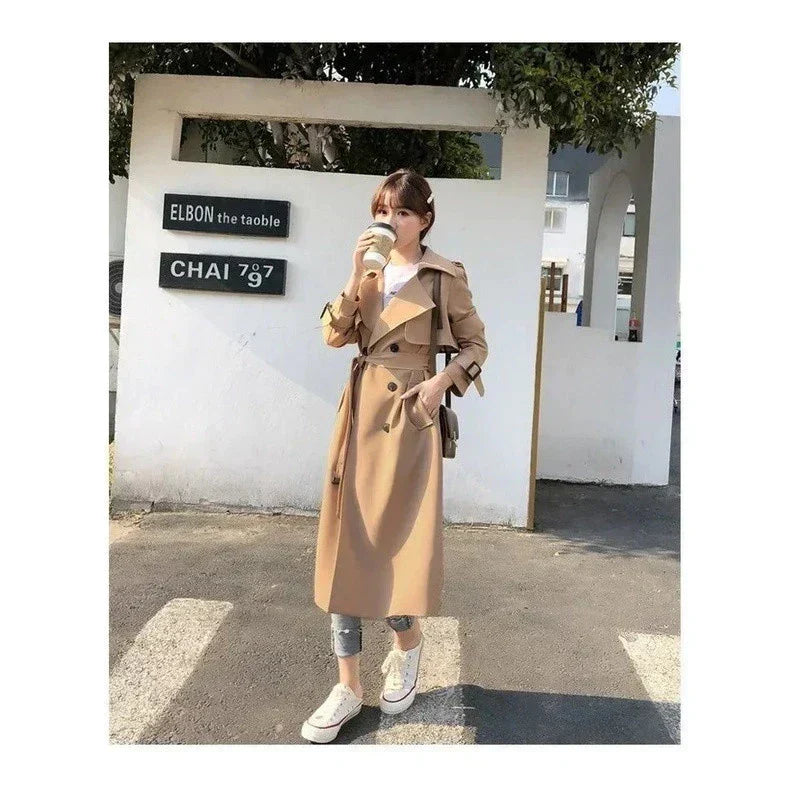 Women's long double-breasted belted trench coat with lapels and cuff buckles