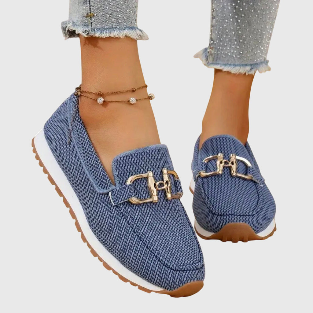 Women's textured slip-on loafers with decorative metal buckle and flat sole