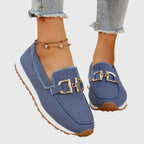 Women's textured slip-on loafers with decorative metal buckle and flat sole