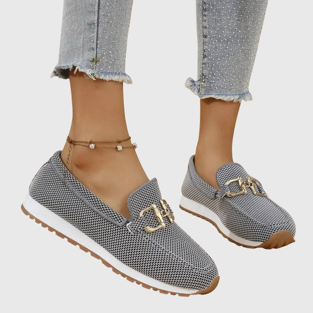 Women's textured slip-on loafers with decorative metal buckle and flat sole