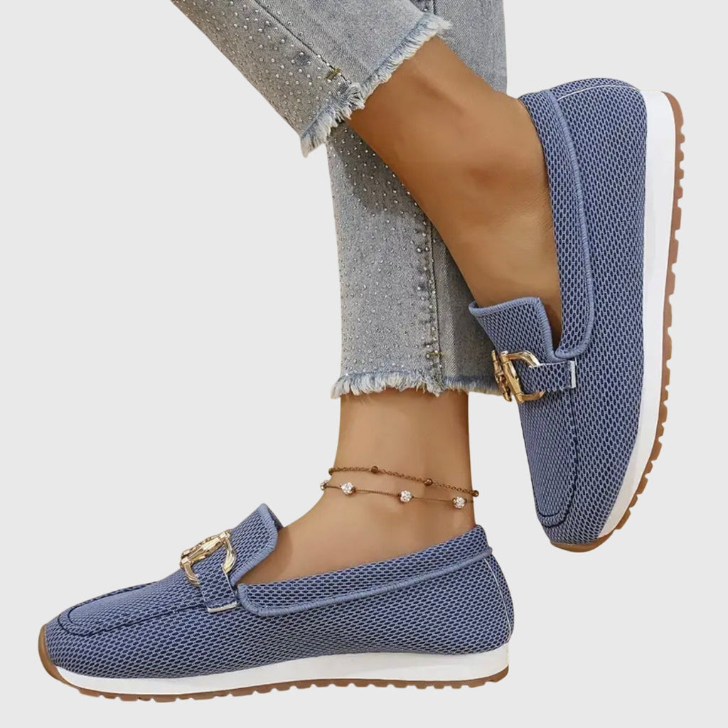 Women's textured slip-on loafers with decorative metal buckle and flat sole