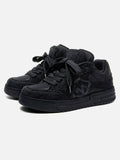 Black high-top skate sneakers with tonal camouflage side panels and lace-up fronts