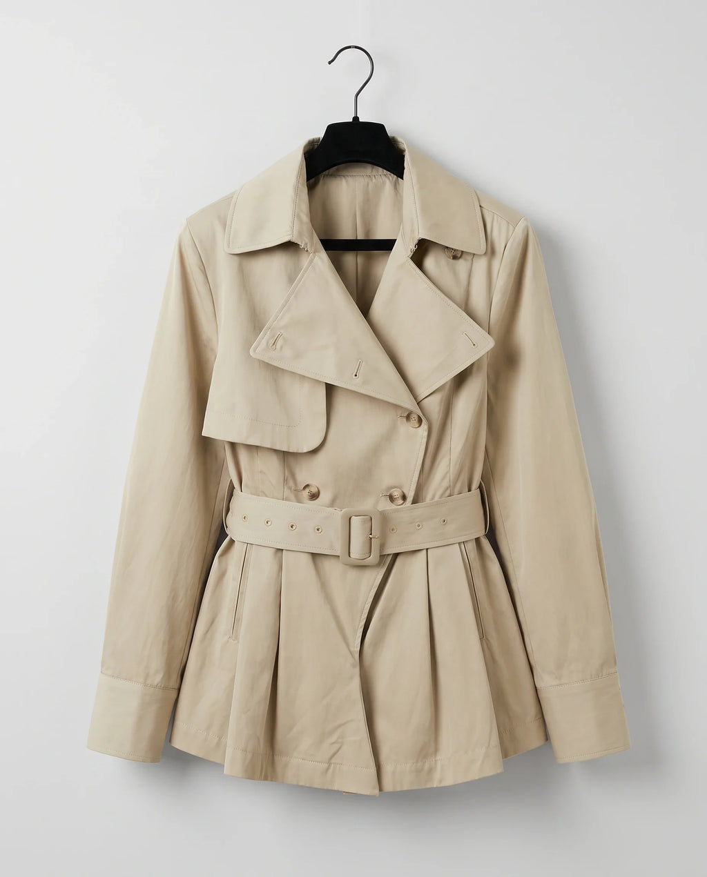 Women's beige long-sleeve trench-style romper with lapels and a belted waist