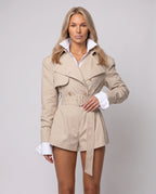 Women's beige long-sleeve trench-style romper with lapels and a belted waist