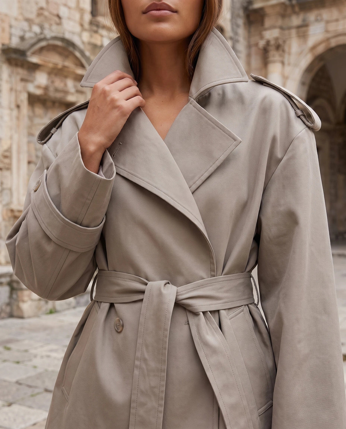 Women's oversized cropped trench jacket with wide lapels and tie belt