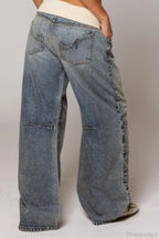 Women's washed blue wide-leg jeans with contrasting curved denim panels