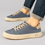 Low-top lace-up trainers with contrast sole and stitched panels