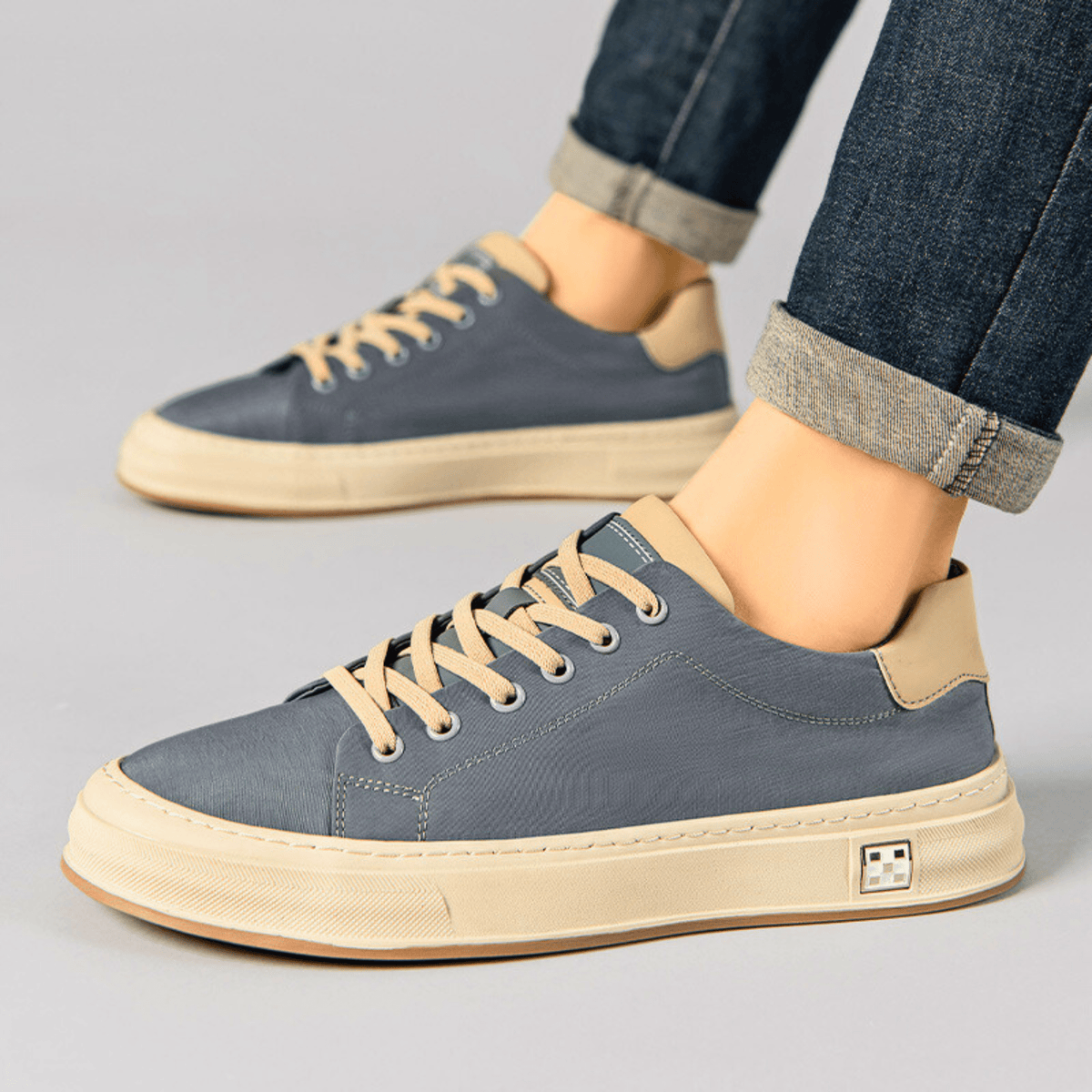 Low-top lace-up trainers with contrast sole and stitched panels