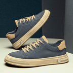 Low-top lace-up trainers with contrast sole and stitched panels