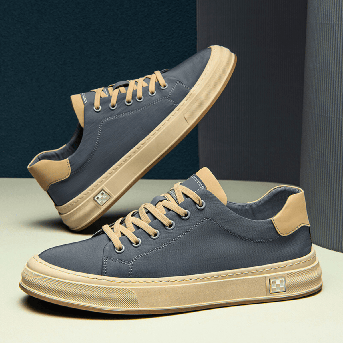 Low-top lace-up trainers with contrast sole and stitched panels