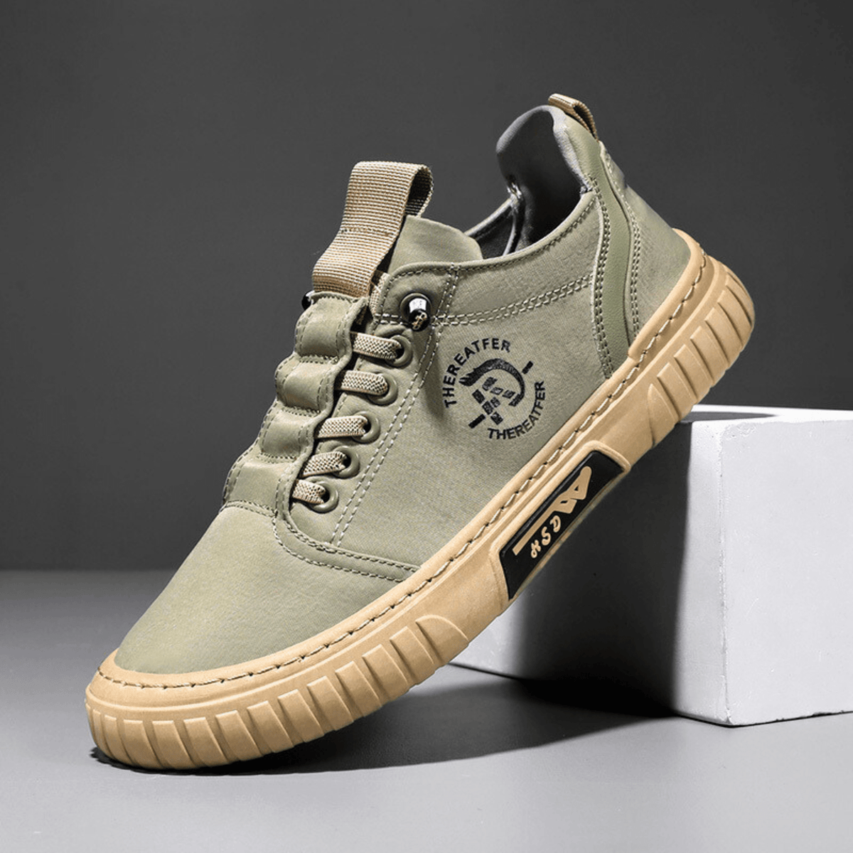 Low-top lace-up casual trainer with stitched panels and textured flat sole