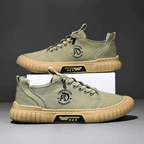 Low-top lace-up casual trainer with stitched panels and textured flat sole