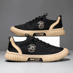 Low-top lace-up casual trainer with stitched panels and textured flat sole