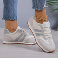 Women's lace-up trainers with striped side panels and flat ridged soles