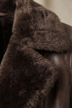 Women's brown shearling-lined jacket with plush collar and front zip