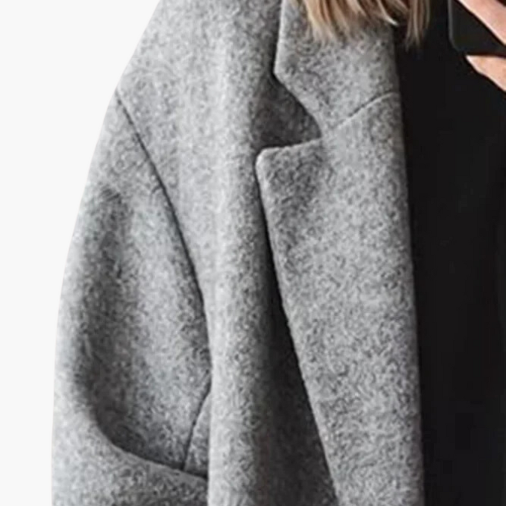 Women's longline coat with notched lapel collar, long sleeves, buttons and side pockets