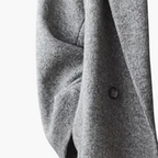 Women's longline coat with notched lapel collar, long sleeves, buttons and side pockets
