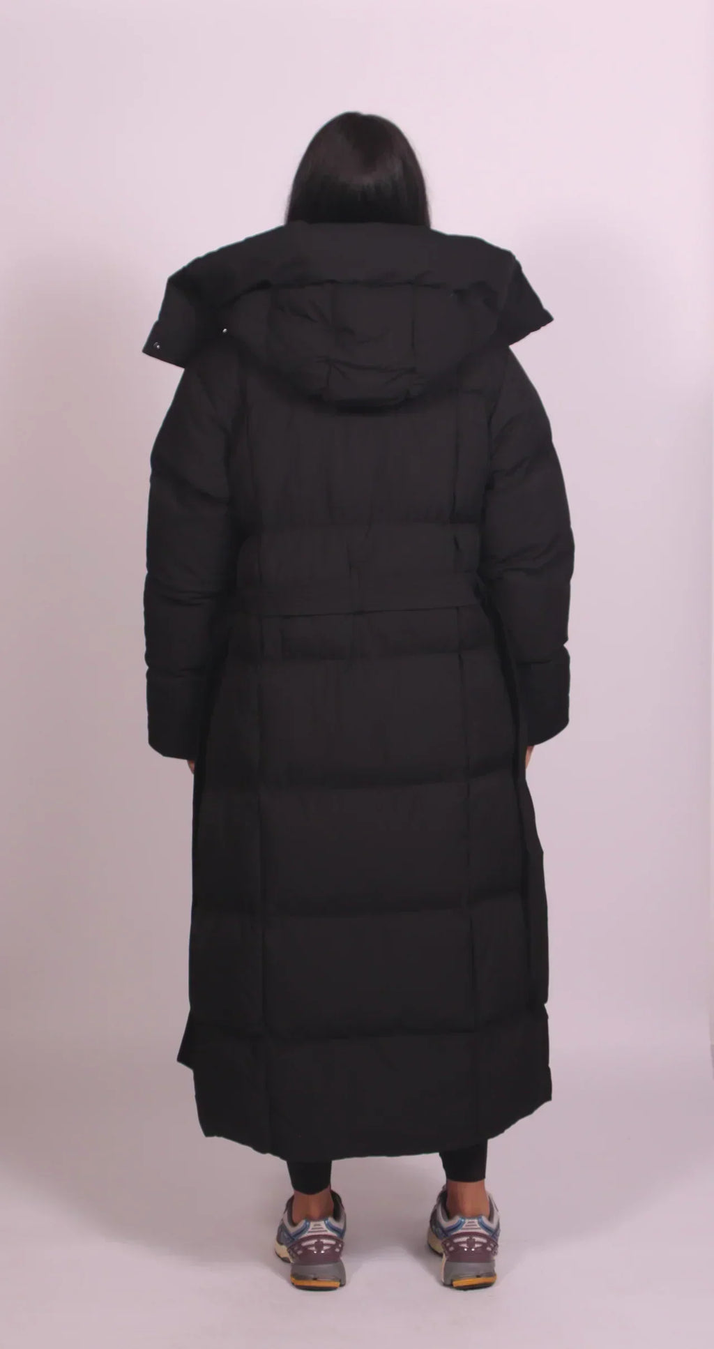 Women's longline quilted puffer coat with hood and tie waist
