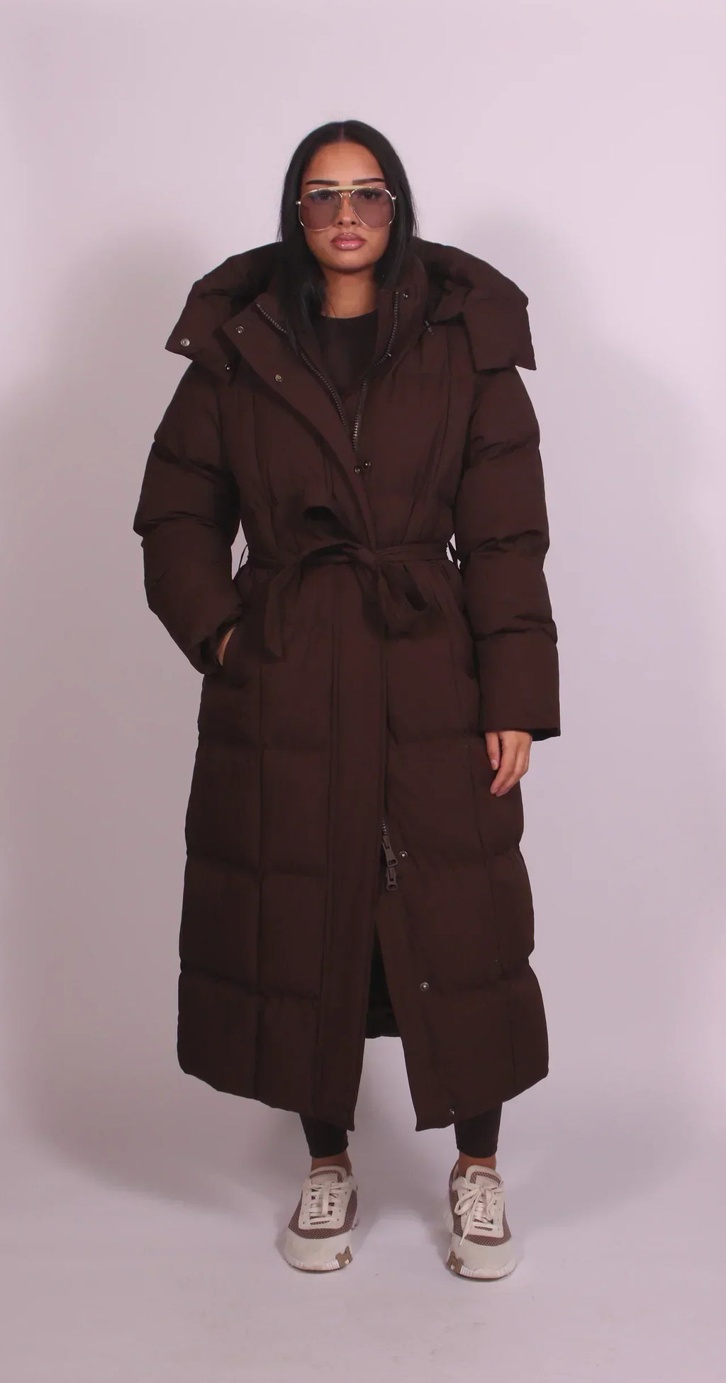 Women's longline quilted puffer coat with hood and tie waist