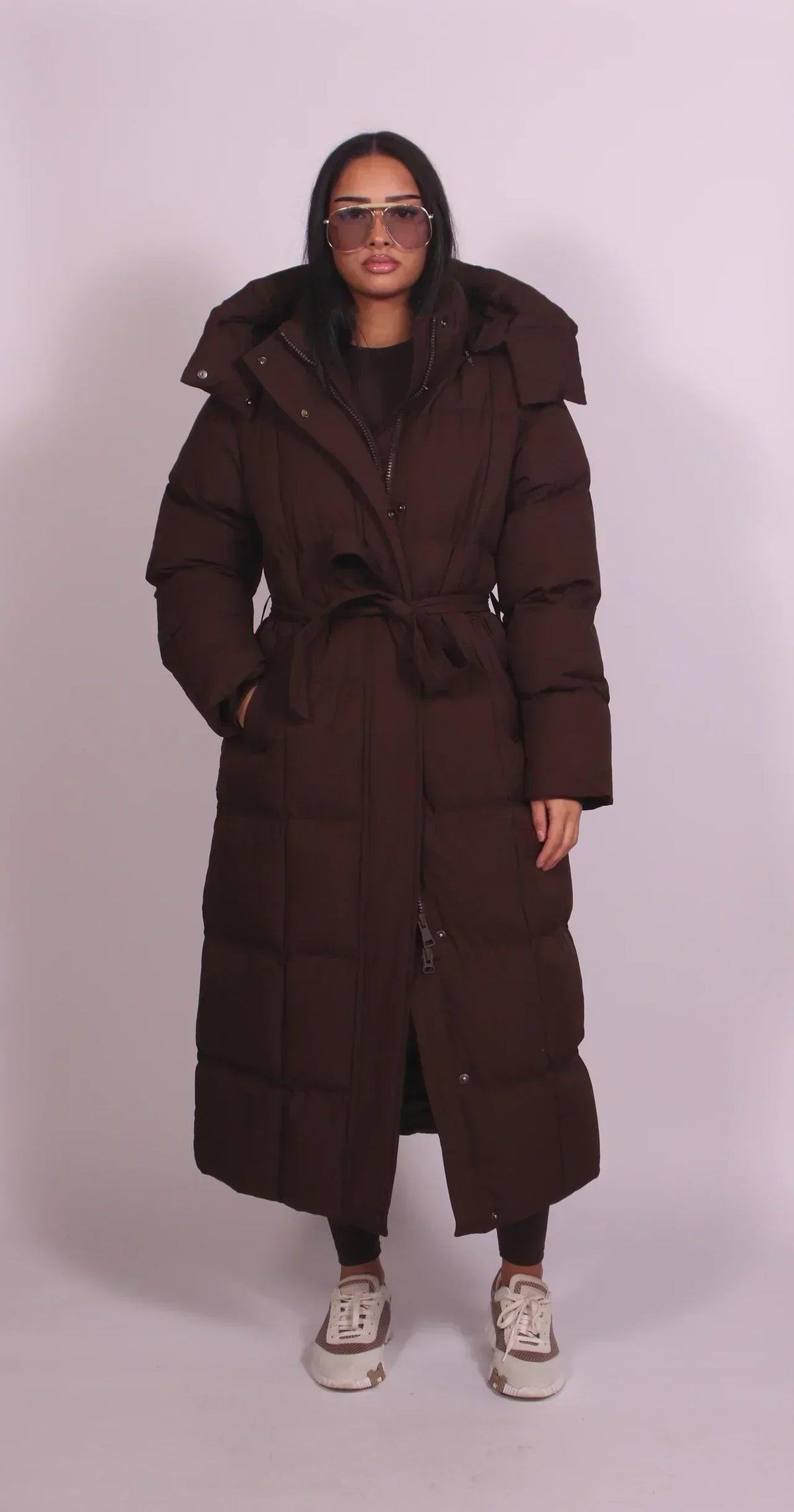 Women's longline quilted puffer coat with hood and tie waist