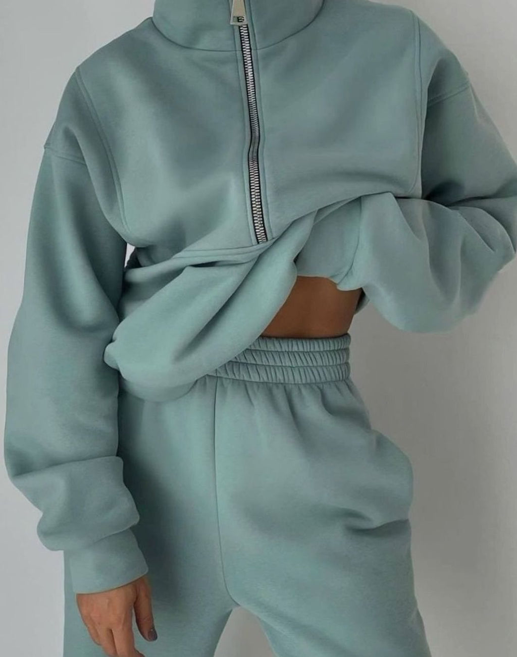 Women's cropped half-zip tracksuit set with raised collar and matching trousers